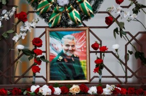Flowers lie around a portrait of Iranian Major-General Qassem Soleimani, who was killed in an airstrike near Baghdad, at the Iranian embassy's fence in Minsk, Belarus January 10, 2020. REUTERS/Vasily Fedosenko