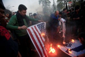 Pakistani Shi'ite Muslim supporters of Majlis-e-Wahdat-e-Muslimeen (MWM) burn U.S and IsraelÕs flags to condemn the death of Iranian Major-General Qassem Soleimani, who was killed in an airstrike near Baghdad, during a protest in Lahore, Pakistan January 3, 2020. REUTERS/Mohsin Raza