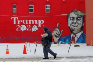 A mailman walks past a mural of U.S. President Donald Trump in Boone, Iowa, U.S., January 27, 2020. REUTERS/Brian Snyder