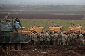 Turkish soldiers gather next to their tanks near the Turkish-Syrian border in Hatay province, Turkey January 23, 2018. REUTERS/Umit Bektas