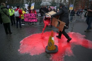 A woman spills red paint from a trolley as demonstrators gather in support of WikiLeaks founder Julian Assange, outside Woolwich Crown Court, ahead of a hearing to decide whether Assange should be extradited to the United States, in London, Britain, February 24, 2020. REUTERS/Hannah Mckay