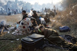 Migrants rest as they await to cross Turkey's Pazarkule border crossing with Greece's Kastanies, in Edirne, Turkey February 29, 2020. REUTERS/Umit Bektas