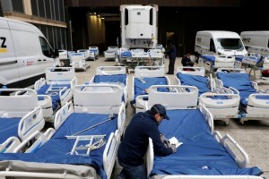 A worker checks part of a delivery of 64 hospital beds from Hillrom to The Mount Sinai Hospital during the outbreak of the coronavirus disease (COVID-19) in Manhattan, New York City, U.S., March 31, 2020. REUTERS/Andrew Kelly