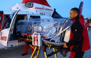 Doctor Mimu Abou Taleb and paramedic Daniel Rowan (R) prepare an " Iso-Arc" safe tent to transport infected patients at the Johanniter air rescue center of rescue helicopter "Christoph Giessen", as the spread of the coronavirus disease (COVID-19) continues, in Giessen, Germany, April 12, 2020. REUTERS/Kai Pfaffenbach
