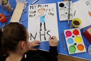 A child at Westlands Primary School paints a poster in support of the NHS as the spread of the coronavirus disease (COVID-19) continues, Newcastle-under-Lyme, Britain, April 2, 2020. REUTERS/Carl Recine TPX IMAGES OF THE DAY