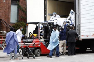 Workers load the body of a deceased person into a truck trailer used to store bodies outside The Brooklyn Hospital Center during the coronavirus disease (COVID-19) outbreak in the Brooklyn borough of New York City, New York, U.S., March 31, 2020. REUTERS/Stefan Jeremiah