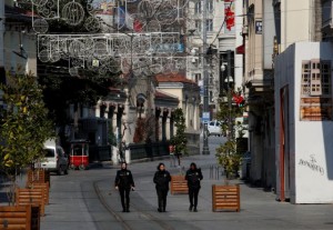 Police officers walk along the deserted Istiklal Street during a two-day curfew which was imposed to prevent the spread of the coronavirus disease (COVID-19), in Istanbul, Turkey, April 11, 2020. REUTERS/Umit Bektas