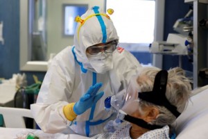 A medical worker wearing an Easter themed headband talks to a patient suffering from the coronavirus disease (COVID-19) at the San Filippo Neri hospital in Rome, Italy, April 4, 2021. REUTERS/Guglielmo Mangiapane