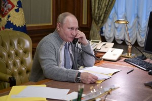 Russian President Vladimir Putin speaks on the phone during a conversation with a participant of a Christmas charity event in Strelna on the outskirts of Saint Petersburg, Russia December 27, 2021. Sputnik/Aleksey Nikolskyi/Kremlin via REUTERS ATTENTION EDITORS - THIS IMAGE WAS PROVIDED BY A THIRD PARTY.